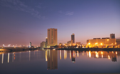 Fototapeta na wymiar Jeddah, Saudi Arabia, sunset over the corniche and the buildings that are reflected in the sea