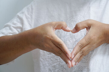 Hand made heart shape, heart shape gesture showing tender feelings.