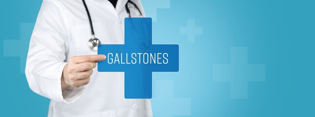 Gallstones. Doctor holding blue cross with medical term on it.