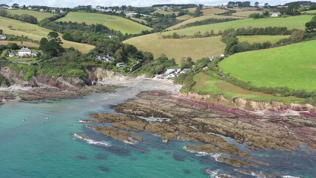 Wide rising aerial view of Talland Bay, Cornwall, UK. Between the town of Looe and village of Polperro.