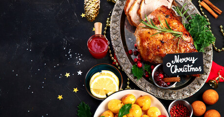 Traditional Christmas dinner on dark background.