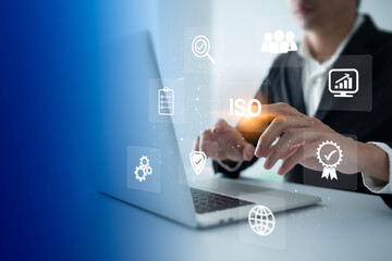 ISO Certification of standards quality control assurance business technology concept. Businessman touching virtual screen iso certification icon to guarantee.