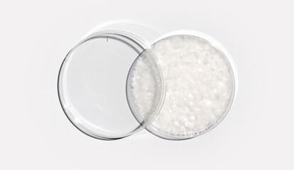 Microcrystalline wax in Petri dish with plastic lid on white laboratory table. Chemical ingredient...