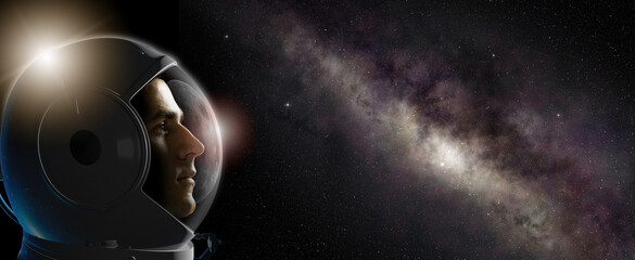 Head shot of astronaut wearing a helmet in outer space looking at the milky way. Concept of space travel and exploration. © Paulista