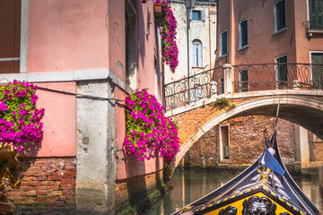 Ornate Gondola in peaceful Canal corner at springtime sunny day, Venice, Italy