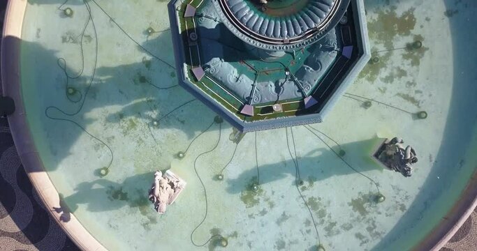 aerial top down of fountain in Praca Dom Pedro IV or Rossio Square towards to portuguese coblestone in Lisbon downtown, Portugal, Europe.