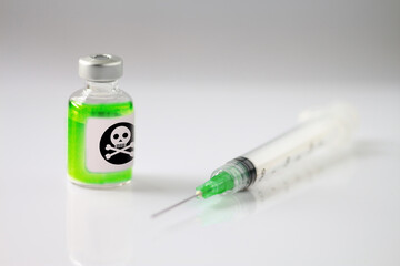 Medical vial of a neon green substance and hypodremic needle. Concept of addiction. 