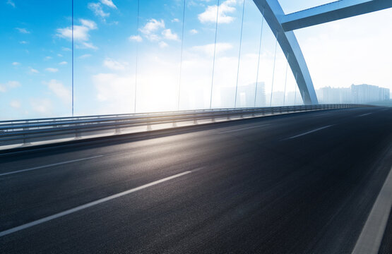 Blurred motion of empty asphalt road bridge under blue sky