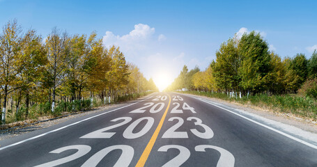 New year 2023 to 2025 written on curved asphalt road