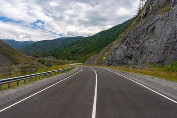A road surrounded by mountains in the Altai Republic. Gorny Altai