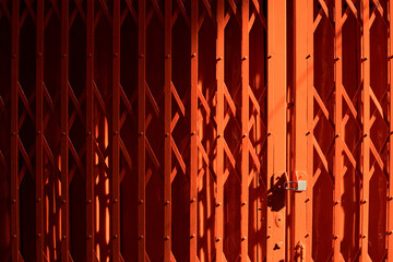 Wrought iron fence gate in bright orange color