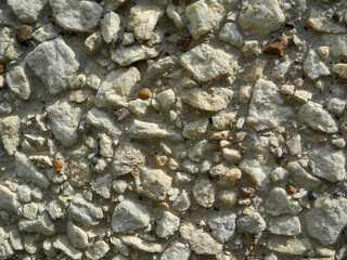 Gray small rocks ground texture. Gravel pebbles stone seamless texture. Background of crushed granite gravel, close up.