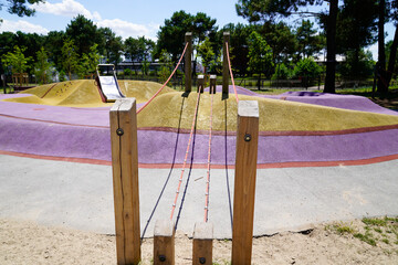Children changing rope path wooden playground on park street - obrazy, fototapety, plakaty