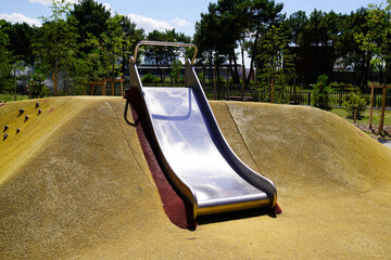 empty children playground with steel dune slide activities in public kid child park modern