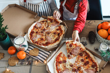 Happy children eat pizza, christmas dinner. The concept of a culinary New Year's master class