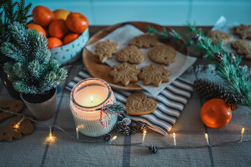 Burning candle, Christmas decor, gingerbread in a festive kitchen