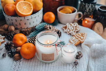 Burning candles on the windowsill in the New Year's decor, atmospheric, aesthetic photography