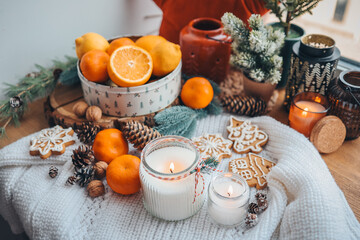 Burning candles on the windowsill in the New Year's decor, atmospheric, aesthetic photography