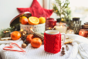 Obraz na płótnie Canvas A cup of hot steaming tea in a New Year's atmosphere, aesthetic photo