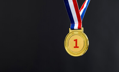 Gold medal on black background