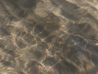 Fototapeta na wymiar A transparent sea wave running over the sand