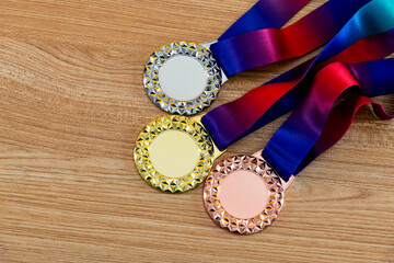 Three medals on wooden table