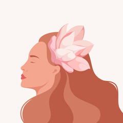 Portrait of a beautiful woman with a flower in her hair. Profile.
