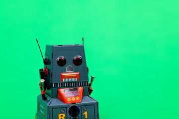 Fototapeta premium Retro robot toy on green background