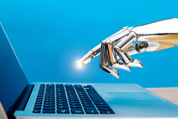 Robot hand pointing to laptop