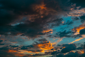Fototapeta na wymiar Dramatic clouds at sunrise. Cinematic cloudy sky backdrop or background photo