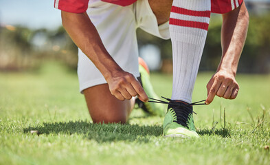 Hands, shoes and soccer player at a soccer field, tie lace and prepare for training, sports and...