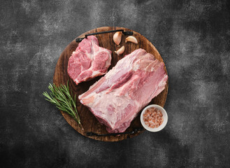 Raw pork neck chop meat with herb leaves and spices on wooden board. Grey background. Top view. - 540618755