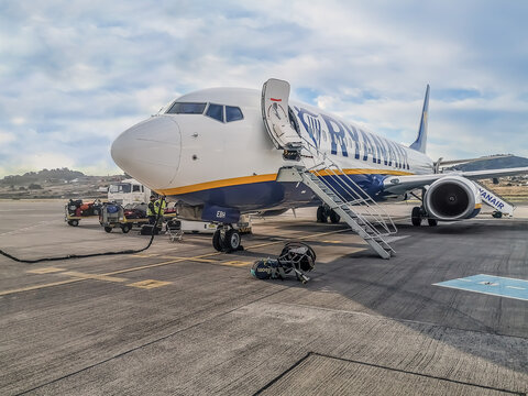 San Cristobal de La Laguna, Spain - November 24, 2021: Ryanair aircraft at Tenerife Norte Airport. Staff retrieve luggage from a landed plane