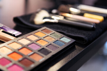 color palette and brushes in the workplace of a professional makeup artist, concept of beauty salon...