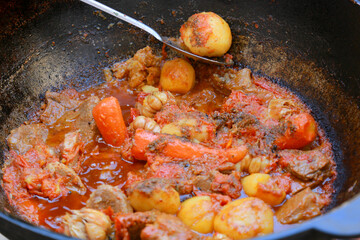 Dimlama - stewed vegetables with the meat in a large Central Asian cauldron.
