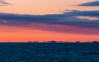 Naklejka na ściany i meble Shimmering horizon over the sea during sunrise