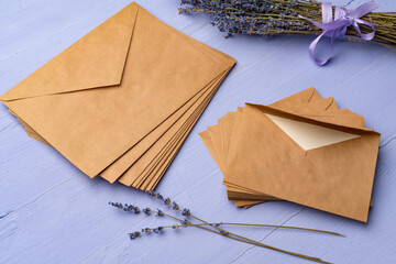 Letter envelope on lavender wooden background, copy space