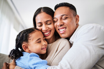 Family hug, happy love and parents with smile for child on sofa in home, care for kid and excited about weekend together in the living room. Girl hugging dad and mom while relax on couch in a lounge