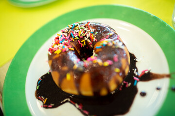 donut with colourful chocolate sprinkles on the plate