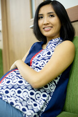 pregnant woman sitting and waiting for turn to check her baby to the doctor