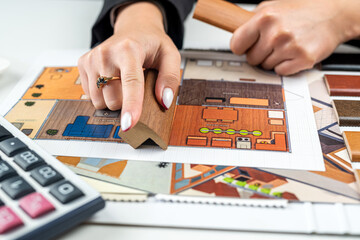 Designer woman plans home interior illustrates chooses perfect colors for new home with samples