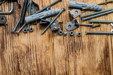 image of sets of plastic dowels shiny metal self-tapping screws in  pile on  table background.