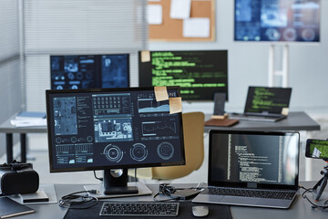 Background image of several computers with data and control panels in IT company office, copy space
