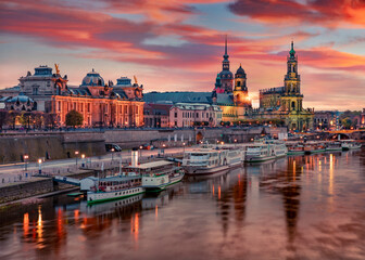 Fototapeta na wymiar Great evennig view of Cathedral of the Holy Trinity or Hofkirche, Bruehl's Terrace or The Balcony of Europe. Nice autumn sunset on Elbe river in Dresden, Saxony, Germany, Europe.