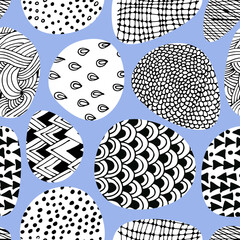 Seamless pattern with clouds with black and white doodle ornaments on blue background