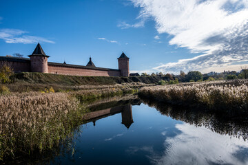 Naklejka na ściany i meble ancient stone monastery against the backdrop of autumn nature in Suzdal