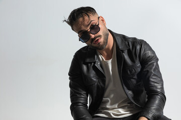 portrait of attractive bearded man with wet hair wearing leather jacket