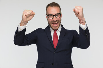 excited businessman is celebrating success with arms in the air