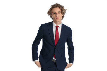 elegant young businessman posing with hands in pockets
