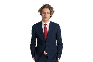 young businessman with blue eyes and curly hair holding hands in pockets